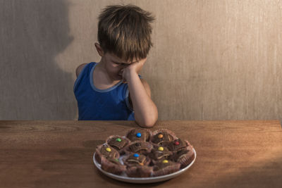 Portrait of boy looking at table