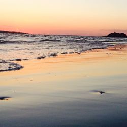 Scenic view of beach at sunset