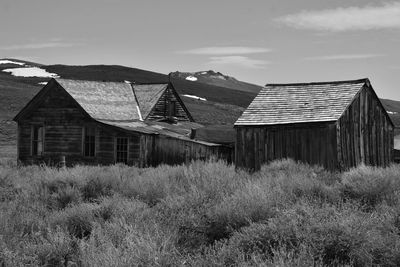 Black and white monochrome at bodie sate historical park in california.  house on a hill.