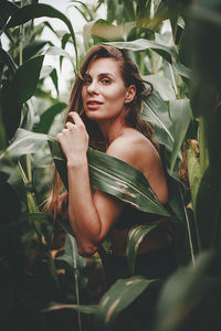 Portrait of young woman in plant