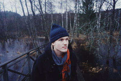 Man in warm clothing at forest during winter