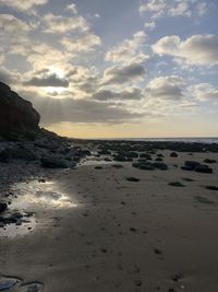 Scenic view of beach against sky during sunset