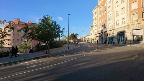City street and buildings against sky