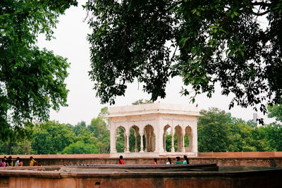 Bridge over river against trees