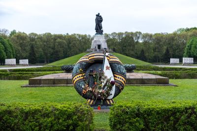 Statue against trees and grass