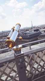 Close-up of railing by street against sky