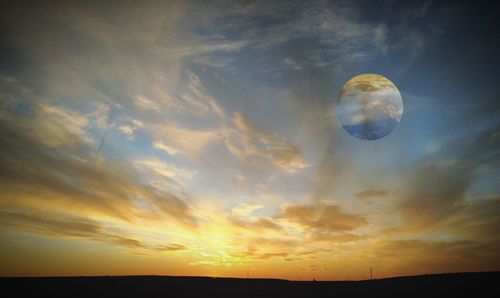 Scenic view of landscape against sky at sunset