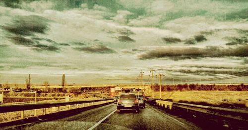 View of railroad tracks against cloudy sky