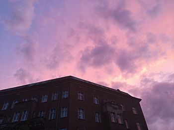 Low angle view of building against cloudy sky