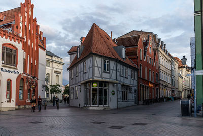 Street amidst buildings in town against sky