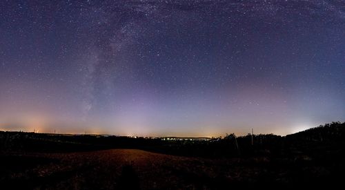 Scenic view of field against star field at night