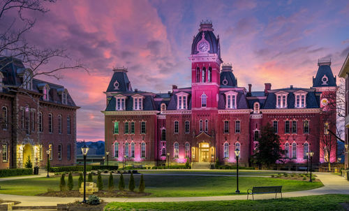 Buildings against cloudy sky at sunset