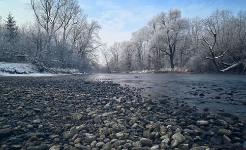 Scenic view of frozen lake against sky during winter