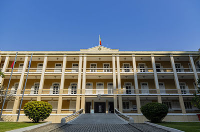 Low angle view of building against clear blue sky