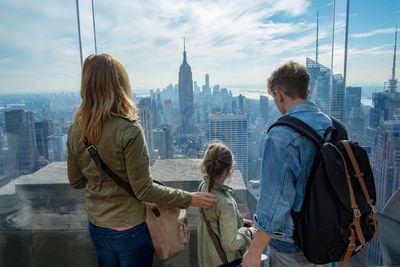 Rear view of people looking at cityscape of new york