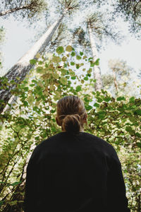 Rear view of man standing in forest