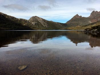 Scenic view of lake and mountains against sky