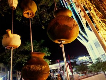 Close-up of bell hanging outside temple against sky