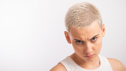 Portrait of young woman against white background