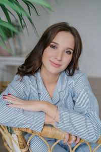 Portrait of a smiling young woman sitting outdoors