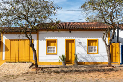 Exterior of house by building against sky