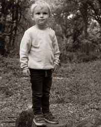 Portrait of boy standing on field