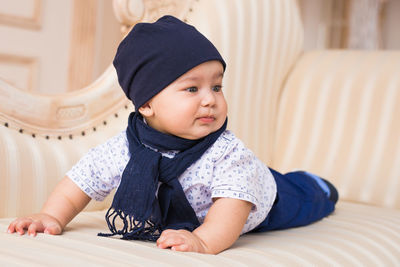 Cute baby boy sitting at home