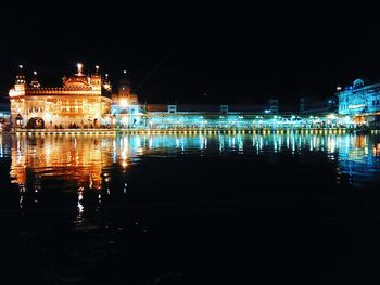 Illuminated buildings with waterfront at night