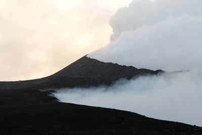 Scenic view of volcanic mountain against sky