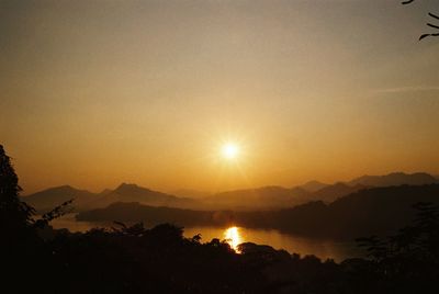 Scenic view of silhouette mountains against sky during sunset