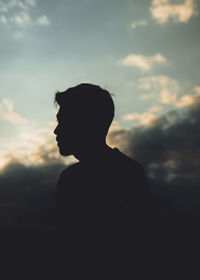 Silhouette man standing against sky during sunset