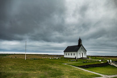 Small church and graveyard  against sky - strandarkirkja iceland