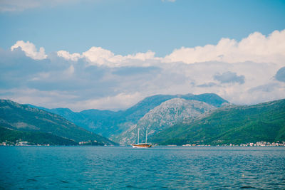 Scenic view of sea and mountains against sky