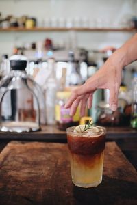 Close-up of hand holding glass of juice