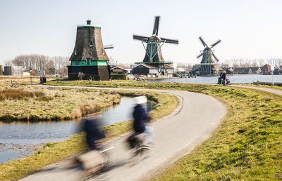 Dutch countryside with rolling mills and people in speed motion