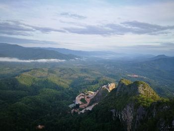 Aerial view of mountain range against cloudy sky