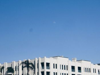 Low angle view of buildings against clear blue sky