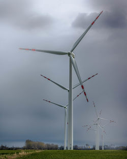 Windmill on field against sky