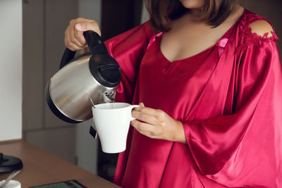 Woman holding coffee cup