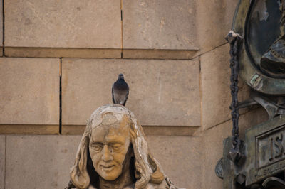 Statue against wall