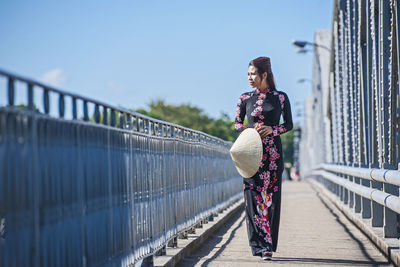 Beautiful woman walking over truong tien bridge in hue / vietnam