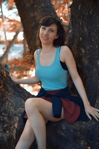 Young woman sitting on rock