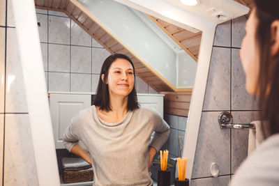 Portrait of woman standing in bathroom