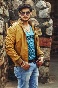 Portrait of young man wearing sunglasses standing outdoors