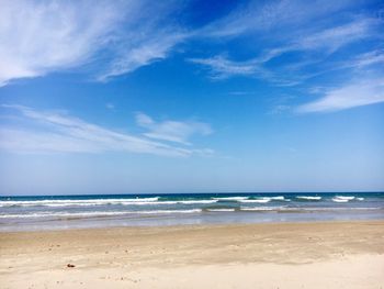 Scenic view of beach against blue sky