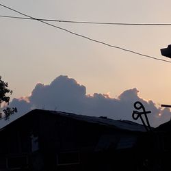 Low angle view of building against sky at sunset