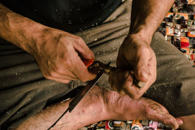 Midsection of man working at workshop