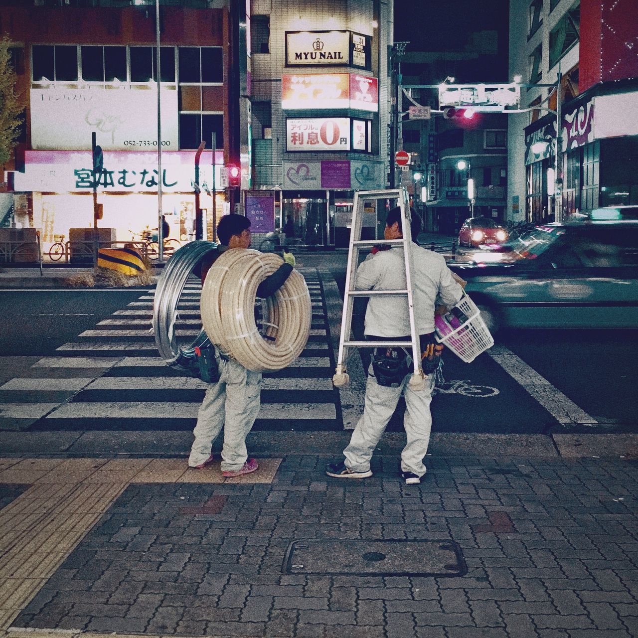 REAR VIEW OF MAN AND WOMAN STANDING ON STREET