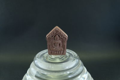 Close-up of water bottle on table against black background