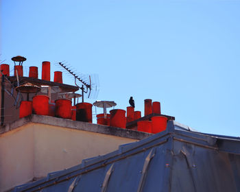 Low angle view of red containers on building